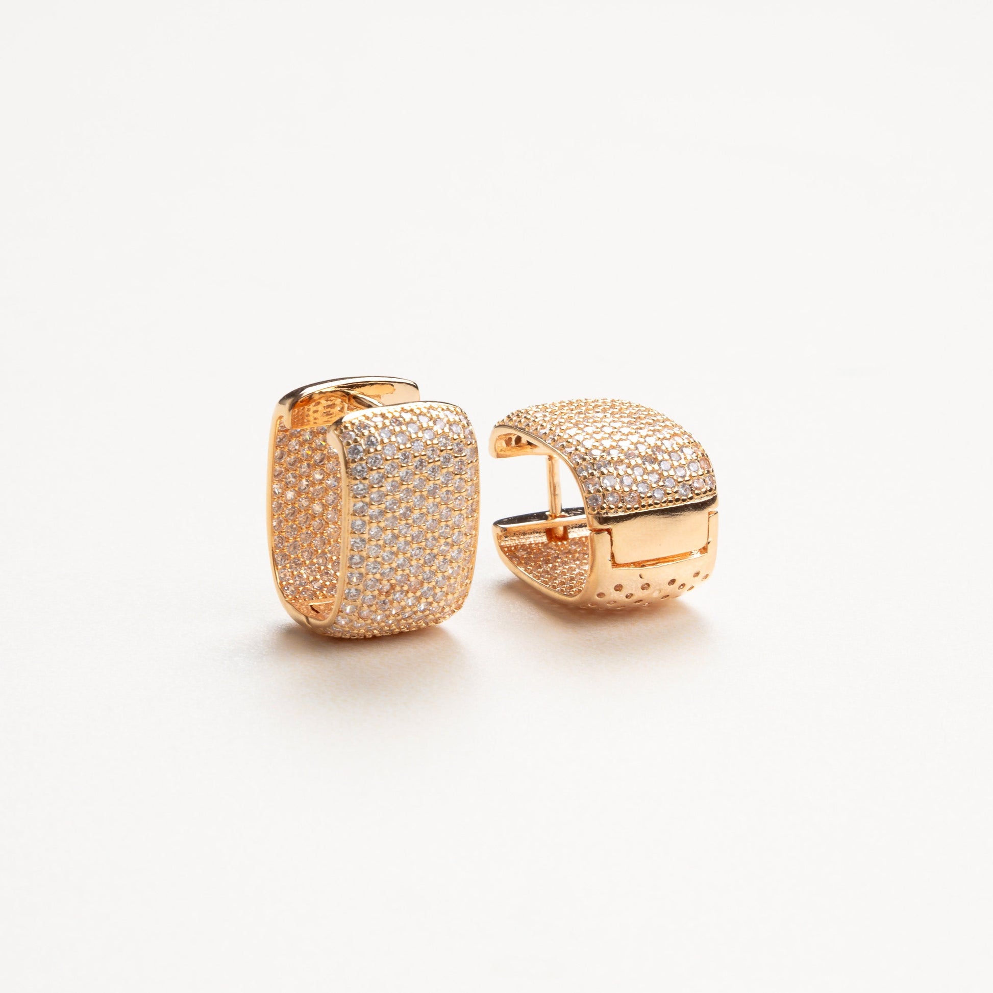 Detalle de los aretes con zirconias de tamaño mediano, mostrando el brillo y la claridad de las piedras, con una estructura delicada que aporta un toque moderno y refinado.